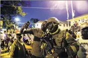  ?? JEROME DELAY / AP ?? People cheer coalition troops from Senegal in the Gambian capital Banjul on Sunday, a day after defeated leader Yahya Jammeh went into exile.