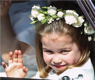  ??  ?? Confident: Charlotte waves to well-wishers as she arrives outside St George’s Chapel
