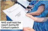  ??  ?? NHS staff hold the report during Mr Corbyn’s speech