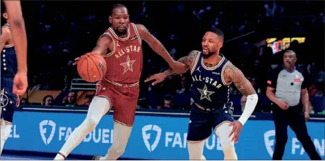  ?? (AP PHOTO/DARRON CUMMINGS ) ?? Phoenix Suns forward Kevin Durant (35) drives on Milwaukee Bucks guard Damian Lillard (0), later named as the 2024 Most Valuable Player, during the first half of the NBA All-Star basketball game in Indianapol­is, Sunday.