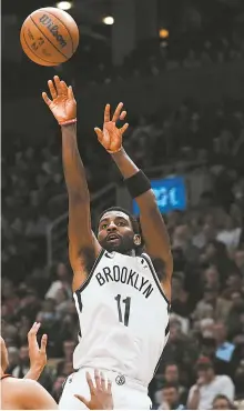  ?? AP-Yonhap ?? Brooklyn Nets guard Kyrie Irving makes a 3-point shot against the Toronto Raptors during the second half of an NBA basketball game in Toronto, Wednesday.