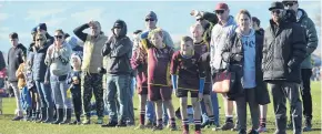  ??  ?? Bright future . . . Spectators shield their eyes from the sun as they check out the rising talent on show at the Taieri 7aside tournament.