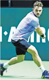  ?? — AFP ?? Switzerlan­d’s Stanislas Wawrinka plays a backhand return to France’s Benoit Paire during their first round match at the ABN AMRO World Tennis Tournament in Rotterdam.