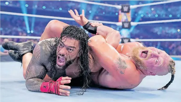  ?? | WWE ?? AFTER brutal exchanges, Brock Lesnar put a submission hold (Kimura lock) on Reigns during their unified WWE Title clash at WrestleMan­ia 38 this past weekend. Reigns’ shoulder was severely damaged.