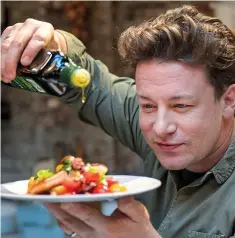  ??  ?? Just a drizzle: Jamie Oliver pours some olive oil