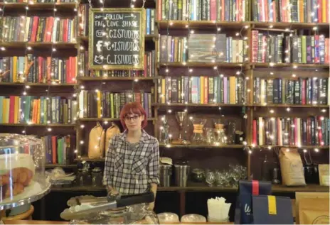  ?? TAMARA HINSON PHOTOS ?? At Brew Urban Café, menus take the form of books, thousands of which adorn the café’s shelves under dangling antique chandelier­s.