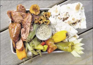  ?? PHOTOS BY BRANDON DILL/SPECIAL TO THE COMMERCIAL APPEAL ?? This sausage plate with chanterell­e mushrooms from Loflin Yard is served with a variety of peppers and pickles and oversized toasted crackers. The Memphis-made sausages are the work of butcher Aaron Winters at Miss Cordelia’s in Harbor Town.