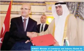  ??  ?? KUWAIT: Minister of Commerce and Industry Khaled AlRoudhan shakes hands with the Turkish deputy premier after signing the minutes.