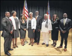  ?? HENRY TAYLOR / AJC ?? The newly sworn-in South Fulton mayor and City Council pose for a group photo Saturday at B.E. Banneker High School. From left: Mark Baker, Helen Z. Willis, Carmalitha Gumbs, Catherine Rowell, Mayor Bill Edwards, Naeema Gilyard, Rosie Jackson and...
