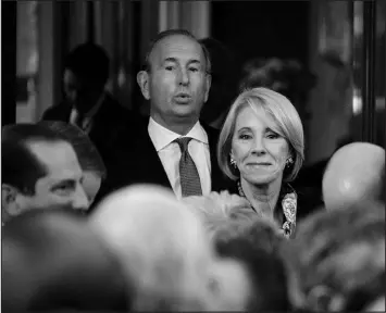  ?? T.J. KIRKPATRIC­K / NEW YORK TIMES FILE (2019) ?? Betsy DeVos, then the education secretary, and her husband, Dick DeVos, attend a White House event Oct. 16, 2019, in Washington. The GOP old guard is protesting the direction of the Michigan Republican Party after it put forward two champions of Donald Trump’s election falsehoods for attorney general and secretary of state.