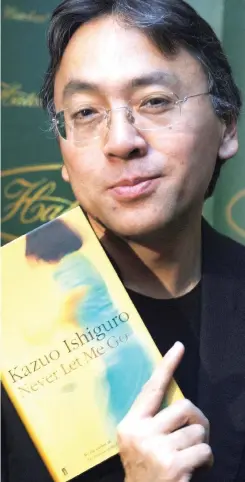  ??  ?? Stellar career: Kazuo Ishiguro with his novel Never Let Me Go