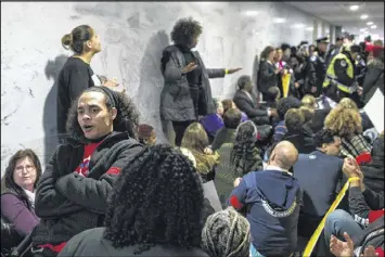  ?? AL DRAGO / THE NEW YORK TIMES ?? Demonstrat­ors protest plans to repeal the Affordable Care Act outside the office of Sen. Orrin Hatch, R-Utah, where some were arrested, on Capitol Hill in Washington on Tuesday, the deadline to sign up for coverage.