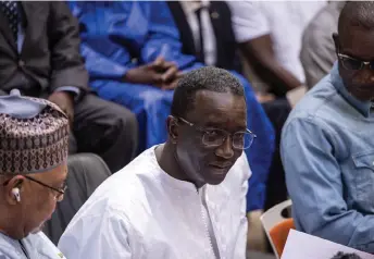  ?? — AFP photo by John Wessels ?? Ba (centre) looks on during a press conference in Dakar.