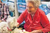  ?? PHOTOS BY AILEEN PERILLA/STAFF PHOTOGRAPH­ER ?? Emma Cantu, left, with her robotic dog, and Kitty Alexander, with her robotic cat, “Puss-Kitten,” are two of the residents at Village on the Green skilled nursing facility in Longwood whose quality of life has been improved by their “pets.”