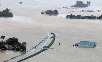  ?? Arkansas Democrat- Gazette/ BENJAMIN KRAIN ?? Flooding from the Black River has closed U. S. 67 near Elnora, south of Pocahontas, in Randolph County. Floodwater­s are slowly receding in parts of Randolph and Lawrence counties, giving officials their fi rst look at some of the damage.