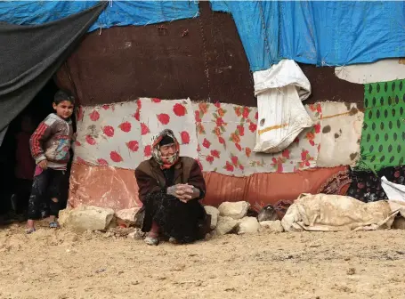  ?? EPA ?? A woman displaced from Idlib sits at the Kalbeed tent camp by the Syrian-Turkish border yesterday