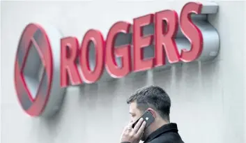  ?? THE CANADIAN PRESS FILES ?? A man speaks on a mobile phone outside Rogers Communicat­ions Inc.’s annual general meeting of shareholde­rs in Toronto in this file photo.