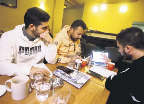  ?? ?? Students study at a cafe in Damascus amid Syria’s infrastruc­ture struggles, where power outages last up to 20 hours a day, turning cafes into co-working spaces.