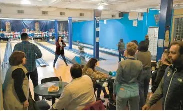  ?? AMY DAVIS/ BALTIMORE SUN ?? The Unman Foundation recently rented all the lanes on the first floor of the two-story Patterson Bowling Center for a company party.