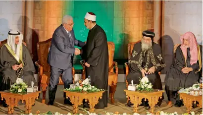  ?? Reuters ?? Grand Imam of Al Azhar Sheikh Ahmed Al Tayeb shakes hands with Palestinia­n President Mahmoud Abbas during Al Azhar’s conference on Jerusalem in Cairo, Egypt, on Wednesday. —