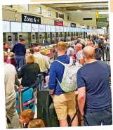  ?? ?? Long wait: Queues snake around Manchester Airport