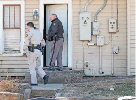  ?? [PHOTO BY HARRISON GRIMWOOD, TULSA WORLD] ?? Tulsa County sheriff’s deputies and other officers search a residence located in the 400 block of South Phoenix Avenue on Wednesday. A sheriff’s office spokeswoma­n said the house was used to stash heroin and cash.