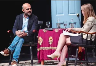  ?? SARAH GORDON/THE DAY ?? Author Mohsin Hamid, left, talks about his novel “Exit West” with Marie Ostby, assistant professor of English, as part of the One Book One Region program at Connecticu­t College’s Palmer Auditorium on Wednesday.