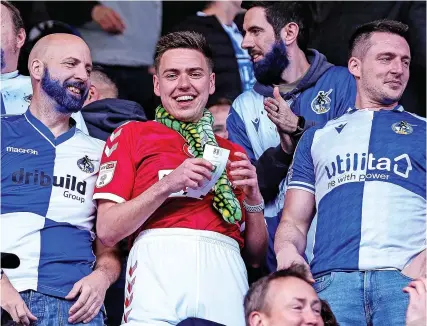  ?? Picture: Ryan Crockett ?? A Bristol Rovers fan on a stag do wearing a Bristol City shirt, much to the amusement of his friends, in the away end at Saturday’s game against Tranmere