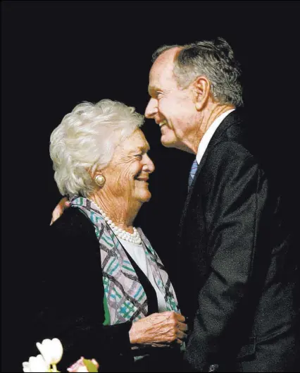  ?? Tony Gutierrez The Associated Press ?? Former President George H.W. Bush embraces Barbara Bush after she introduces him at the Genesis Women’s Shelter Mother’s Day Luncheon in Dallas in May 2006.