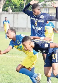  ?? PATRICK PLANTER/ PHOTOGRAPH­ER ?? Players from Hydel High and Jamaica College battling for the ball during the ISSA-FLOW Manning Cup second-round match at the Spanish Town Prison Oval on Wednesday. From left are Rodari Edwards of Hydel High, JC’s Tevin Rochester (8), and Malick Howell (20) of JC. JC won 3-1.