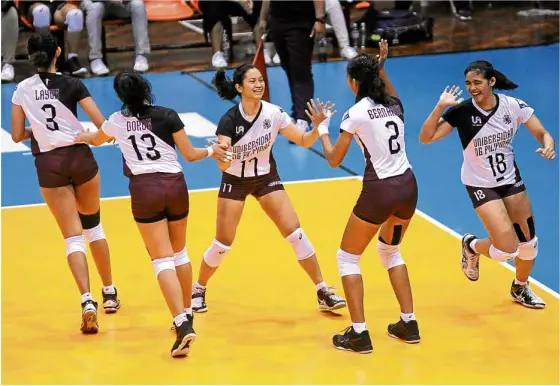  ?? —AUGUST DELA CRUZ ?? The Lady Maroons whoop it up after the final point against the Lady Spikers.