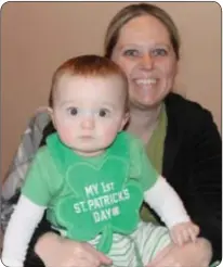  ?? Photograph­s by Cary Beavers ?? Braydon Lafferty enjoys his first St. Patrick’s Day with mom Meredith at The Irish Rover Station House Saturday.
