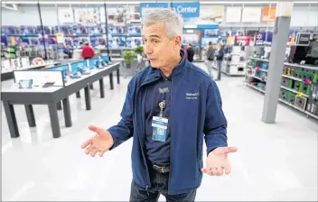  ?? AP PHOTO ?? In this Nov. 9 photo Walmart U.S. President and CEO Greg Foran talks about the electronic­s department during a tour of a Walmart Supercente­r in Houston. Foran took over as CEO of the discounter’s U.S. division four years ago.