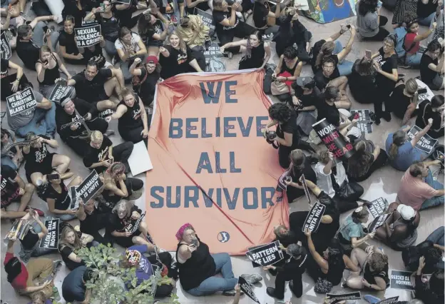  ??  ?? Protesters unfurl a sign as they occupy a Senate building during a rally against Supreme Court nominee Brett Kavanaugh on Capitol Hill in Washington, DC yesterday