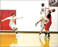  ?? TIMES photograph by Annette Beard ?? Blackhawk senior Cole Wright leaps into the air to block a shot by an Exeter Tiger Monday as Weston Church runs to assist.