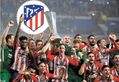  ??  ?? Atletico Madrid’s Fernando Torres and teammates celebrate with the trophy after winning the Europa League by defeating Marseille 3-0 in the final at Stade de Lyon, France, on Wednesday. — Reuters