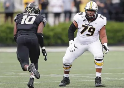  ?? MARK HUMPHREY/AP ?? Larry Borom (shown against Vanderbilt) started 16 games at right tackle for Missouri in the last two seasons.