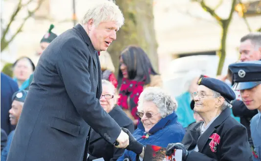  ?? AP ?? Britain’s Prime Minister Boris Johnson (left), greets a veteran as he attends a remembranc­e service on Armistice Day, the 101st anniversar­y of the end of the First World War, in Wolverhamp­ton on Monday while on the General Election campaign trail.