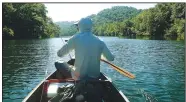  ?? NWA Democrat-Gazette/FLIP PUTTHOFF ?? Darr makes his way downstream. Table Rock Lake was backed up into the Beaver tailwater on July 19, making the float more like a lake trip than river.