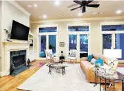  ??  ?? The home’s family room has a fireplace and ample sitting room.