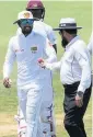  ??  ?? ROW Aleem Dar shows the ball to Dinesh Chandimal