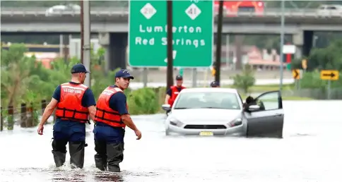  ??  ?? Members of the Coast Guard help a stranded motorist in the flood waters caused by Hurricane Florence in Lumberton, North Carolina. — Reuters photo