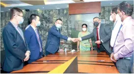  ??  ?? NAITA Chairman Tharanga Gamlath and Huawei Sri Lanka CEO Liang Yi exchange signed MOU documents with a token of goodwill in the presence of Skills Developmen­t, Vocational Education, Research and Innovation State Minister Dr. Seetha Arambepola (middle) and ministry and NAITA officials