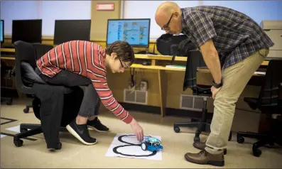  ?? Herald photo by Tijana Martin @TMartinHer­ald ?? Brad Roberts, right, helps his student Nickolas Von Chorus with his robot project at Victoria Park High School on Tuesday. Coding is a perfect example of an area of interest a student can focus on for the ICE Awards, but the options are endless....