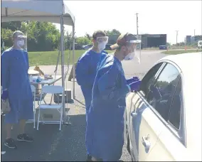  ?? RICHARD PAYERCHIN— THE MORNING JOURNAL ?? Ohio National Guard medics get ready to use a nasal swab to test a person for novel coronaviru­s in a drive-thru event held Aug. 24, at Black River Landing in Lorain. The event was hosted with the National Guard, Lorain County Health & Dentistry, the city of Lorain and Mako Medical testing company.