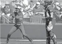  ?? SARAH PHIPPS/ THE OKLAHOMAN ?? OU’s Jayda Coleman, left, celebrates a run next to Baylor catcher Zadie LaValley during a game in March.