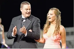  ?? Jeremy Stewart ?? Lindsey Lee (right) reacts after being announced as the 2020 Cedartown High School Homecoming Queen during halftime of Friday’s football game against Pickens as her dad, David Lee, celebrates.