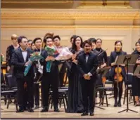  ?? HEZI JIANG / CHINA DAILY ?? Composer Peng Rongxin (foreground) takes a bow with musicians after his recital at Carnegie Hall on Friday.