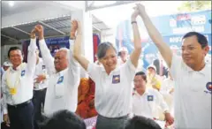  ?? PHA LINA ?? CNRP president Kem Sokha and (from left) deputies Pol Ham, Mu Sochua and Eng Chhay Eang raise hands at a meeting yesterday.