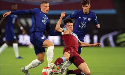  ??  ?? West Ham’s Declan Rice slides to try to dispossess Chelsea’s Ross Barkley at the London Stadiumon 1 July. Photograph: Adam Davy/NMC Pool/PA Wire/PA